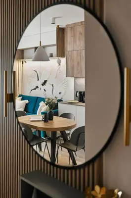 a table and chairs in a room with a mirror at Golden Dreams Luxury Apartments 103 in Kraków