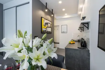 a kitchen with white flowers in a vase on a table at NEW APARTMENT! Jewish quarter! in Kraków