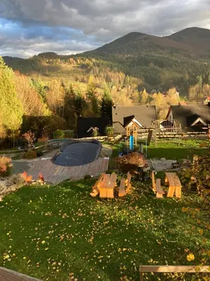 a view of a yard with a pool and a house at Zawoja Nad Koroną z jacuzzi in Zawoja
