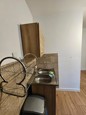 a kitchen with a sink and a chair at Zawoja Nad Koroną z jacuzzi in Zawoja