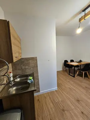 a kitchen with a sink and a table in a room at Zawoja Nad Koroną z jacuzzi in Zawoja