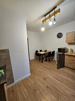 a kitchen and dining room with a table and chairs at Zawoja Nad Koroną z jacuzzi in Zawoja