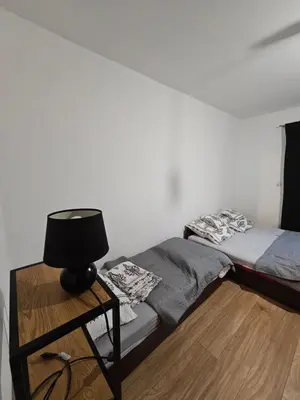 a bedroom with a bed and a lamp on a table at Zawoja Nad Koroną z jacuzzi in Zawoja