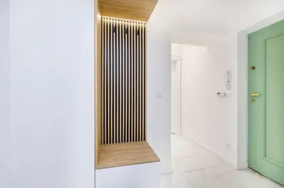 a hallway with a radiator and a green door at Wielopole 7 Apartment 2 rooms in Kraków