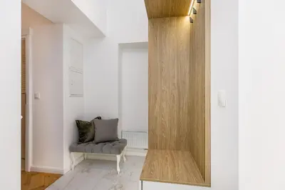 a room with a mirror and a chair in it at Wielopole 7 Apartment 2 rooms in Kraków