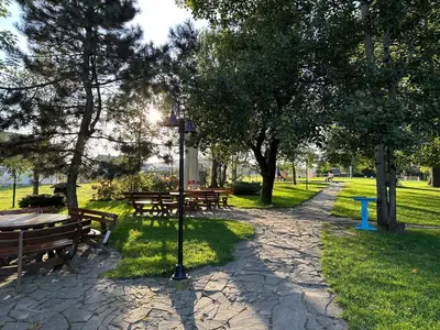 a park with benches and a street light and trees at Restauracja i Hotel Oberża Wilczy Głód in Krzyszkowice