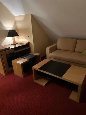 a living room with a couch and a table at Restauracja i Hotel Oberża Wilczy Głód in Krzyszkowice
