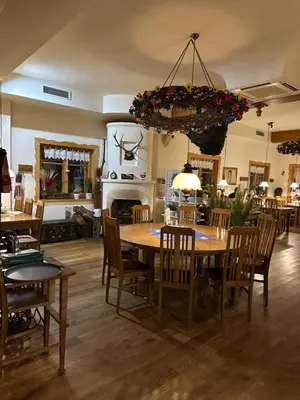 a dining room with a wooden table and chairs at Restauracja i Hotel Oberża Wilczy Głód in Krzyszkowice