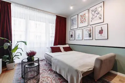 a bedroom with a bed and a large window at Tomasza 25 Apartament 3 in Kraków