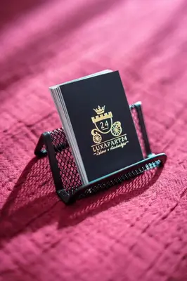 a book sitting on top of a pink bed at Tomasza 25 Apartament 3 in Kraków