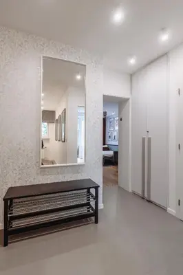 a living room with a bench and a mirror at Tomasza 25 Apartament 3 in Kraków