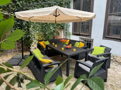 a table and chairs under an umbrella at Studio Flat With a View in Kraków