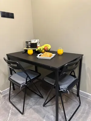 a black table with a plate of food on it at Studio Flat With a View in Kraków