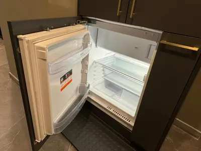an empty refrigerator with its door open in a kitchen at Studio Flat With a View in Kraków