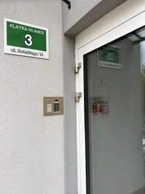 a door to a building with a sign on it at Mieszkaj U Marty w GRÓDKU in Jaworzno