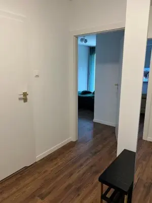 an empty room with a door and a wooden floor at Mieszkaj U Marty w GRÓDKU in Jaworzno
