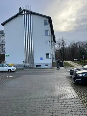 a large white building with a large rectangle at Mieszkaj U Marty w GRÓDKU in Jaworzno