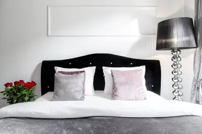 a white bed with four pillows and a lamp at Househost Apartment:Łobzowska 22 in Kraków