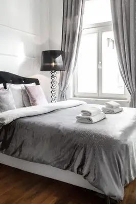 a bedroom with a large bed with a window at Househost Apartment:Łobzowska 22 in Kraków