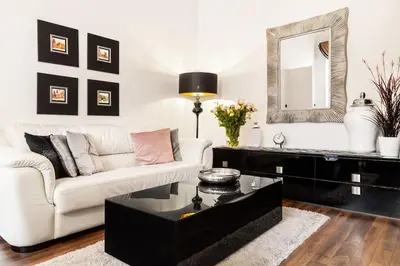 a living room with a white couch and a mirror at Househost Apartment:Łobzowska 22 in Kraków