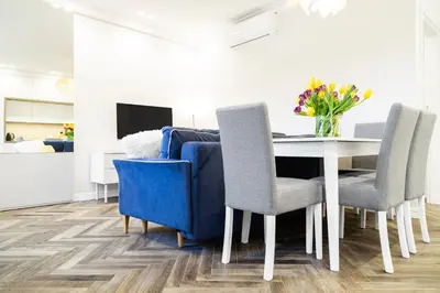 a dining room with a table and chairs at HOUSEHOST Apartment : Sarego Street in Kraków