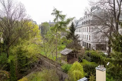 a view of a building in a city with trees at HOUSEHOST Apartment : Sarego Street in Kraków