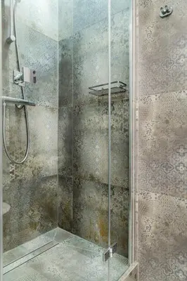 a shower with a glass door in a bathroom at HOUSEHOST Apartment : Sarego Street in Kraków