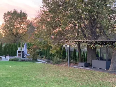 a garden with a gazebo and a tree at Stodoła Chillout Apartments in Marszowice