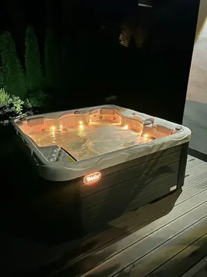 a hot tub sitting on a table with lights at Stodoła Chillout Apartments in Marszowice