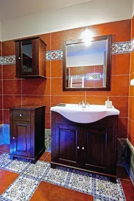 a bathroom with a sink and a mirror at Noclegi Styrnol & SPA in Zawoja