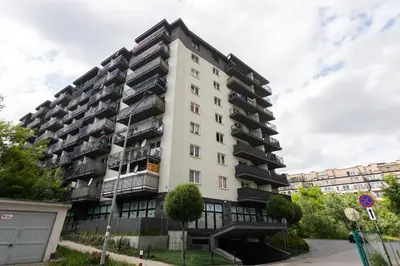 a tall white apartment building with balconies at Zlota Jesien apartment by NEARTO PL in Kraków