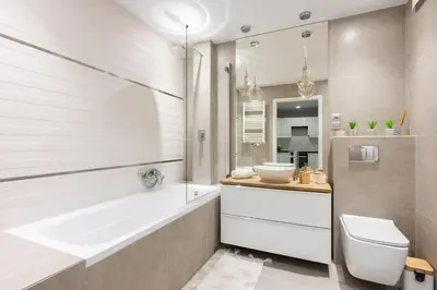 a bathroom with a tub and a toilet and a sink at Zlota Jesien apartment by NEARTO PL in Kraków