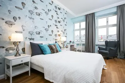 a bedroom with a bed and a white brick wall at MINT Luxury Apartments at the Main Square in Kraków