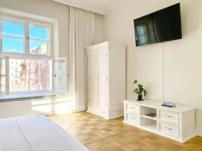 a living room with a couch and a table at MINT Luxury Apartments at the Main Square in Kraków