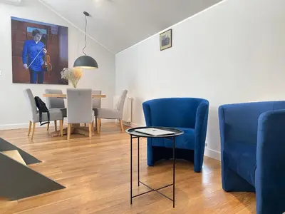 a living room with a couch and a table at MINT Luxury Apartments at the Main Square in Kraków