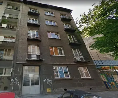 a tall building with windows and balconies on a street at Studio near Old Town in Kraków