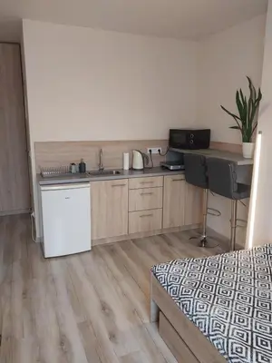 a kitchen with a sink and a desk in a room at Studio near Old Town in Kraków