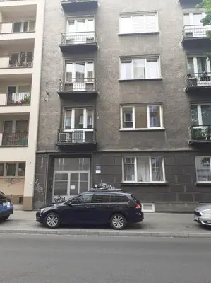 a black car parked in front of a building at Studio near Old Town in Kraków