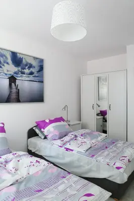 a bedroom with two beds and a picture on the wall at Kraków Cosy 3 room 2 bathroom Old Town in Kraków
