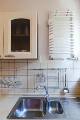 a kitchen with a sink and a window and a stove at Kraków Cosy 3 room 2 bathroom Old Town in Kraków