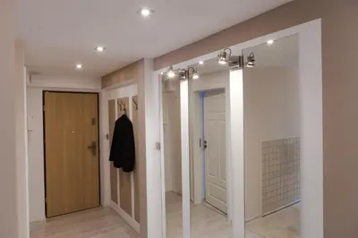 a hallway with two mirrors and a closet at Kraków Cosy 3 room 2 bathroom Old Town in Kraków