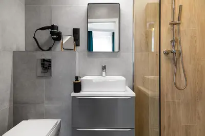 a bathroom with a sink and a mirror at HOUSEHOST Apartments: Miodowa 42/12b Street in Kraków
