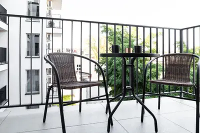 two chairs and a table on a balcony at HOUSEHOST Apartment: Miodowa 42/12a Street in Kraków