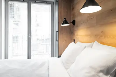a bedroom with a white bed and a window at HOUSEHOST Apartment: Miodowa 42/12a Street in Kraków