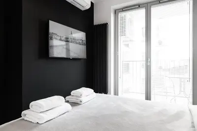 a bedroom with a bed with three towels on it at HOUSEHOST Apartment: Miodowa 42/12a Street in Kraków