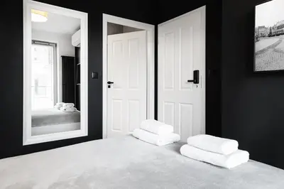 a bedroom with a white bed with two pillows on it at HOUSEHOST Apartment: Miodowa 42/12a Street in Kraków