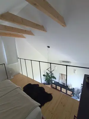 a bedroom with a bed and a wooden floor at Green corner in Kraków