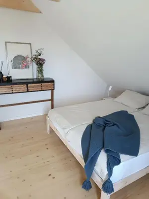 a bedroom with a bed with a blue blanket on it at Green corner in Kraków