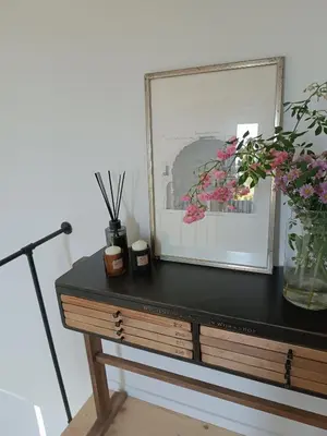 a dresser with a black top with flowers on it at Green corner in Kraków