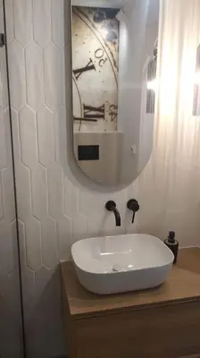 a bathroom with a white sink and a mirror at Green corner in Kraków